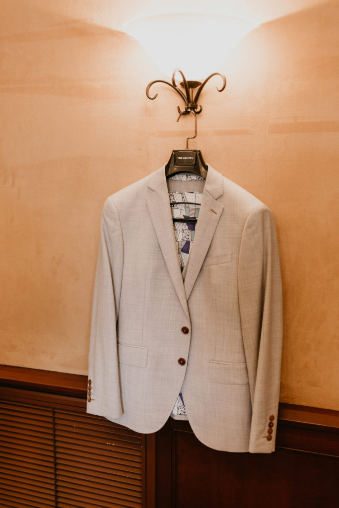A music festival themed wedding at The Inn at Rancho Santa Fe, groom light grey suit