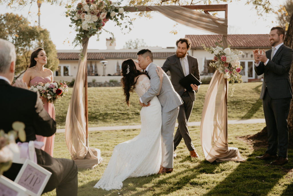 A music festival themed wedding ceremony at The Inn at Rancho Santa Fe, bride and groom first kiss