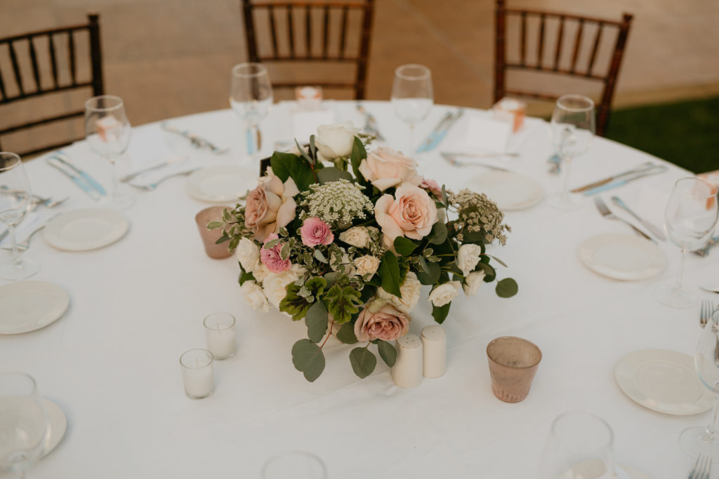A music festival themed wedding reception at The Inn at Rancho Santa Fe, pink and white floral centerpiece