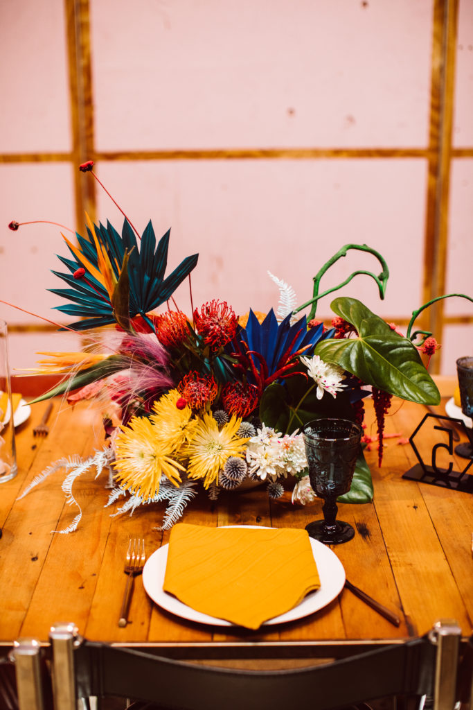 A unique and colorful wedding reception at the Grass Room in downtown Los Angeles, bright and eclectic table centerpieces