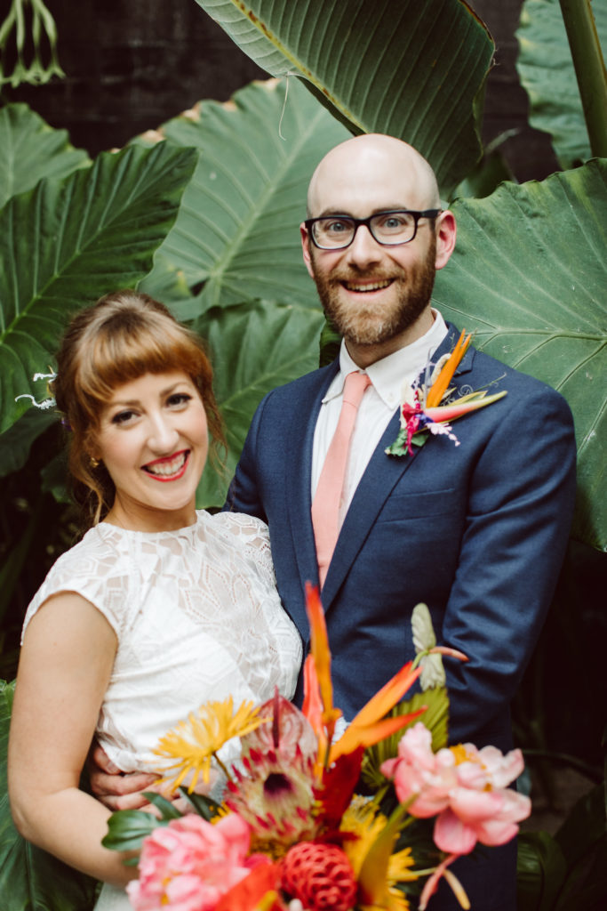 A unique and colorful wedding at the Grass Room in downtown Los Angeles, bride and groom portrait shot with rainbow inspired chuppah