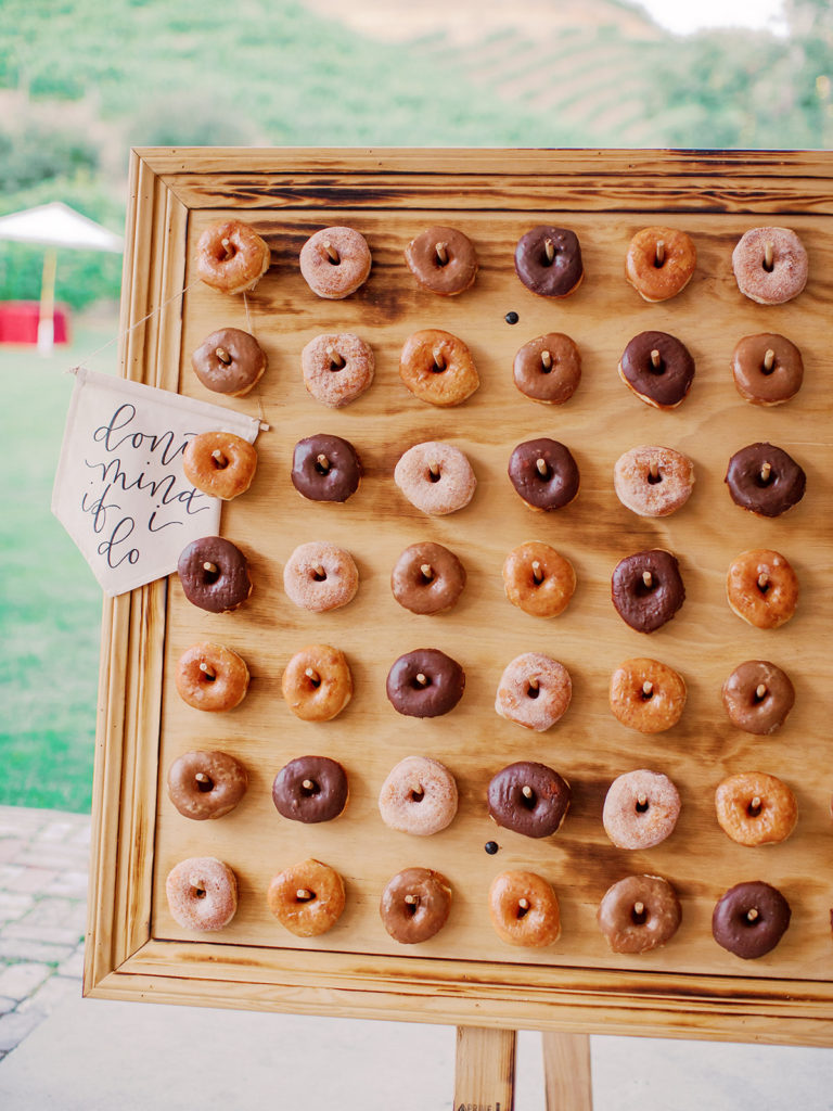 A colorful and vibrant wedding at Triunfo Creek Vineyards, donut wall sign