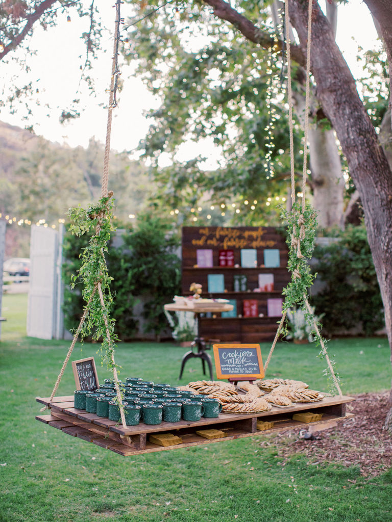 A colorful and vibrant wedding at Triunfo Creek Vineyards, cookie and camper mug display