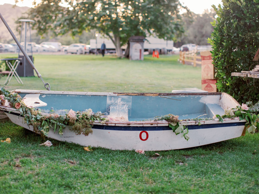 A colorful and vibrant wedding at Triunfo Creek Vineyards, cocktail hour boat with drinks 