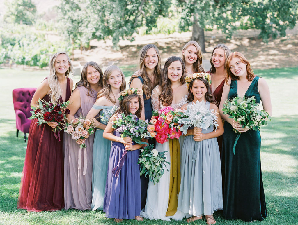 A colorful and vibrant wedding at Triunfo Creek Vineyards, bridesmaids in mix matching colorful dresses and bouquets