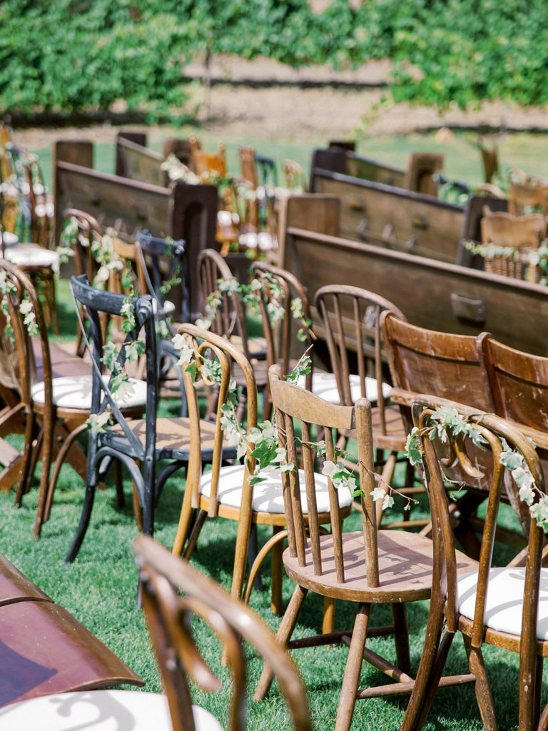A colorful and vibrant wedding ceremony at Triunfo Creek Vineyards, mix and matching chairs