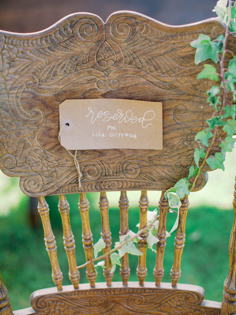 A colorful and vibrant wedding ceremony at Triunfo Creek Vineyards, reserved sign