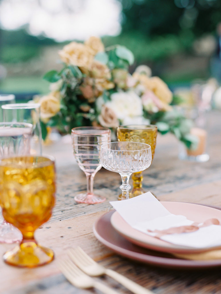 A colorful and vibrant wedding reception at Triunfo Creek Vineyards, pink and yellow table set up