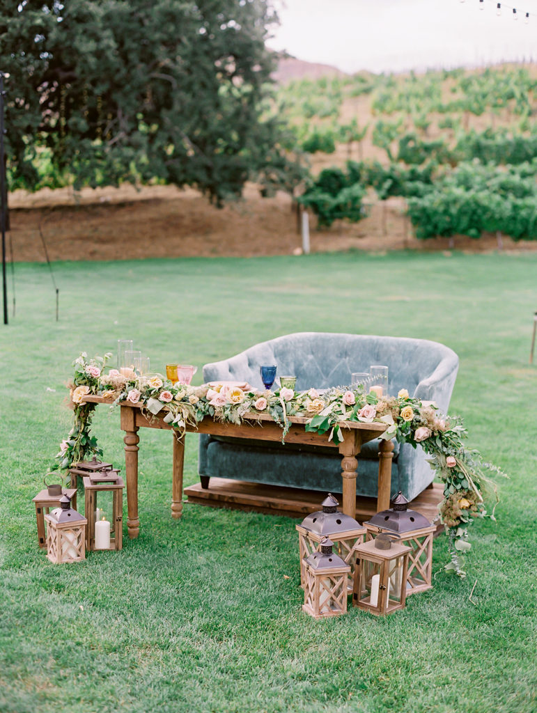 A colorful and vibrant wedding reception at Triunfo Creek Vineyards, blue sweetheart couch