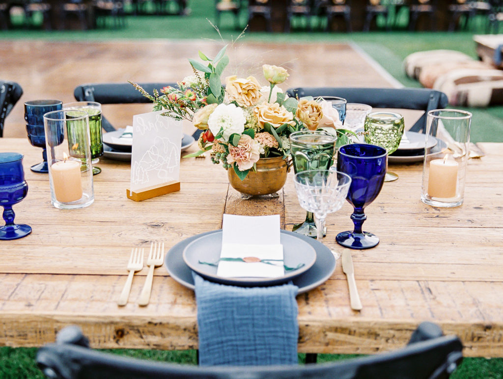 A colorful and vibrant wedding reception at Triunfo Creek Vineyards, blue and green table set up