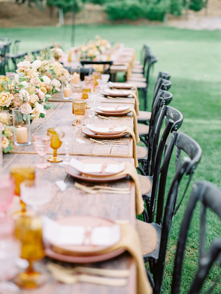 A colorful and vibrant wedding reception at Triunfo Creek Vineyards, pink and yellow table set up