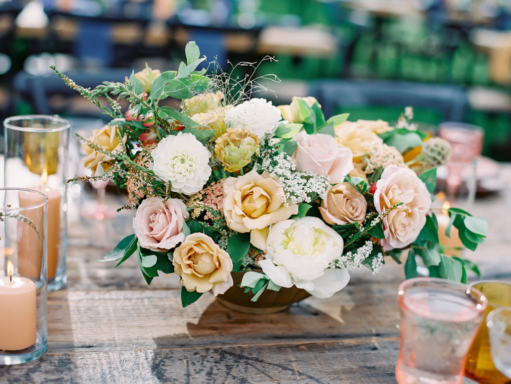 A colorful and vibrant wedding reception at Triunfo Creek Vineyards, romantic flower arrangement