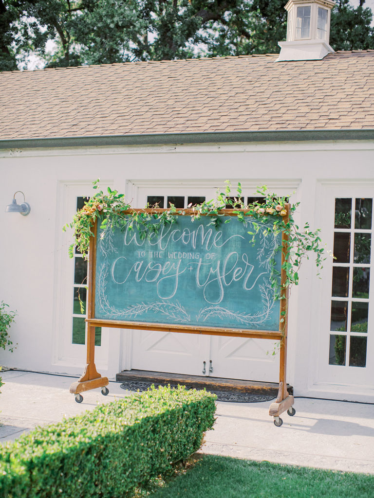 A colorful and vibrant wedding at Triunfo Creek Vineyards, chalkboard welcome sign