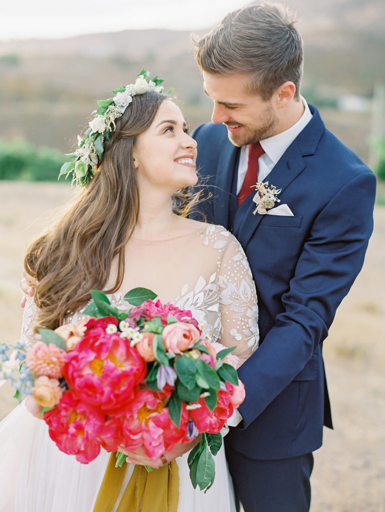 A colorful and vibrant wedding at Triunfo Creek Vineyards, sunset bride and groom portrait shot, colorful bridal bouquet with yellow ribbon