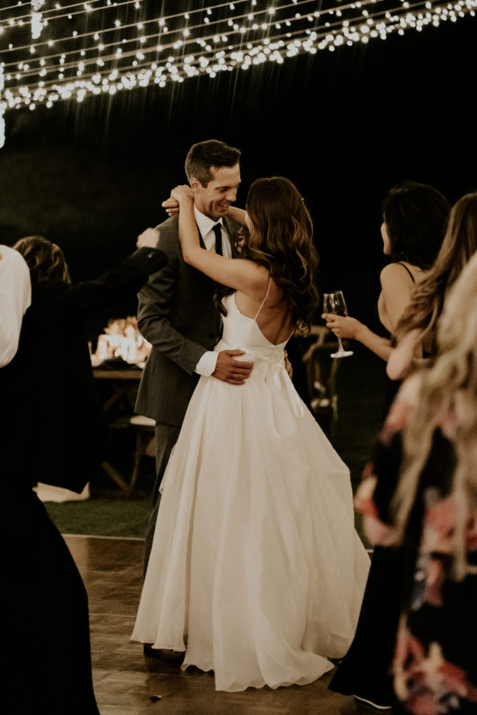 A whimsical wedding reception at Triunfo Creek Vineyards, bride and groom dance