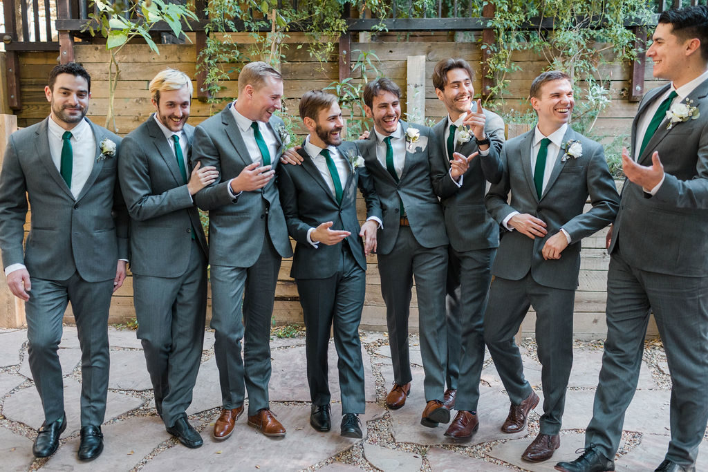 A Romantic Forest Inspired Wedding at the 1909, groom and groomsmen in dark grey suits with green ties