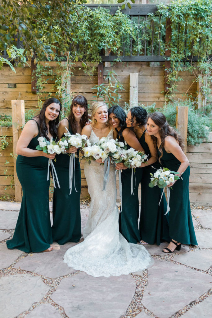 A Romantic Forest Inspired Wedding at the 1909, bride with bridesmaids in emerald bridesmaid dresses