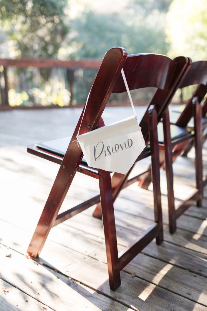 A Romantic Forest Inspired Wedding outdoor ceremony at the 1909, hanging reserved chair sign