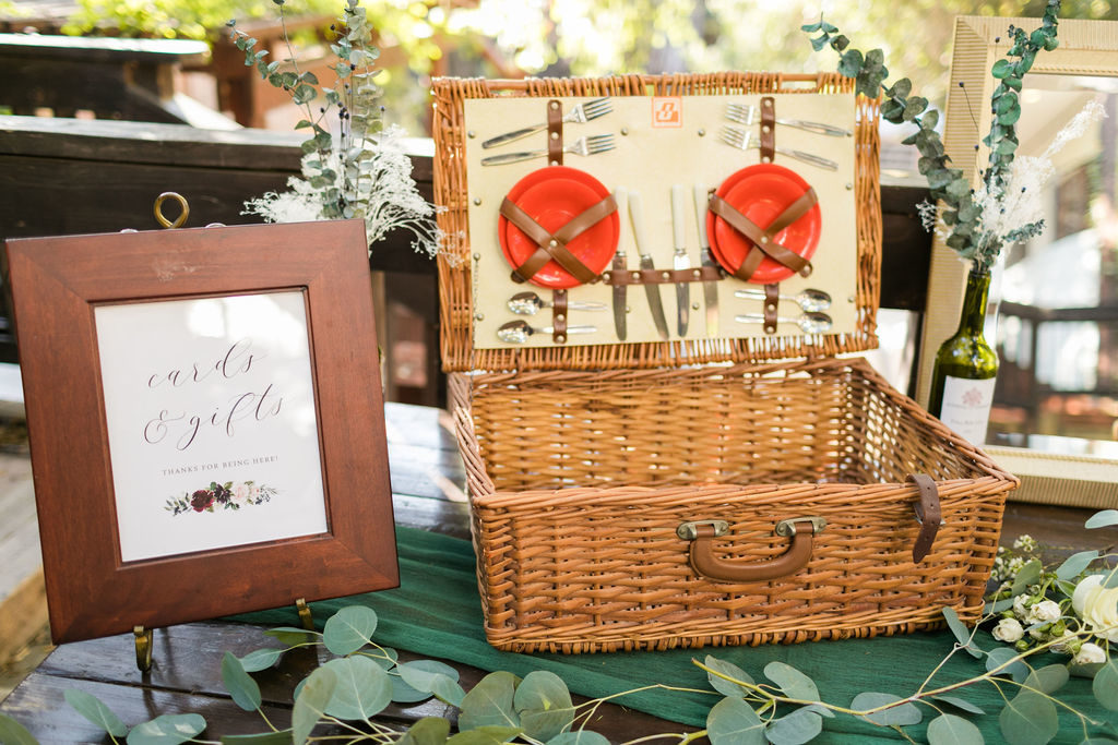 A Romantic Forest Inspired Wedding at the 1909, welcome table with picnic basket 