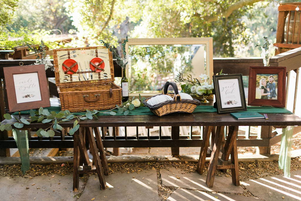 A Romantic Forest Inspired Wedding at the 1909, welcome table with picnic basket