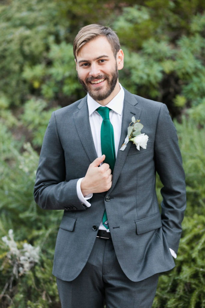 A Romantic Forest Inspired Wedding at the 1909, groom in dark grey suit with green tie