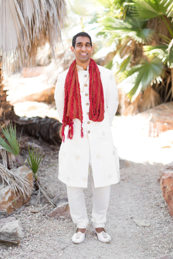 Traditional Indian groom wearing red scarf