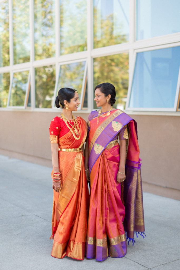 Bridal portrait shot with bride and mother wearing red wedding saree