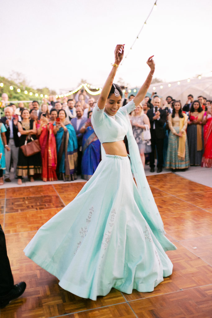 bride in mint wedding saree dancing at her reception