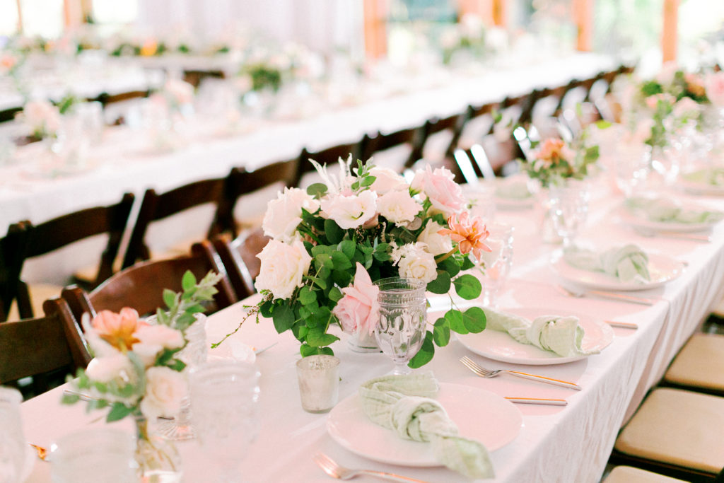 Wedding reception at the Environmental Nature Center, neutral draping with white linen and green floral centerpieces