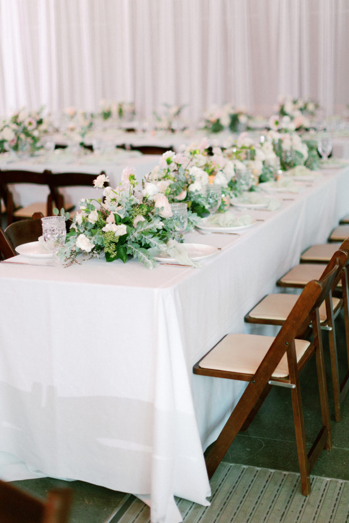 Wedding reception at the Environmental Nature Center, neutral draping with white linen and green floral centerpieces