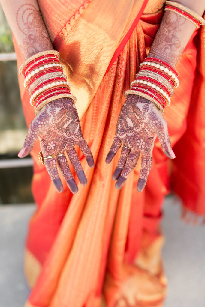 Bridal portrait shot with henna tattoos and bangles