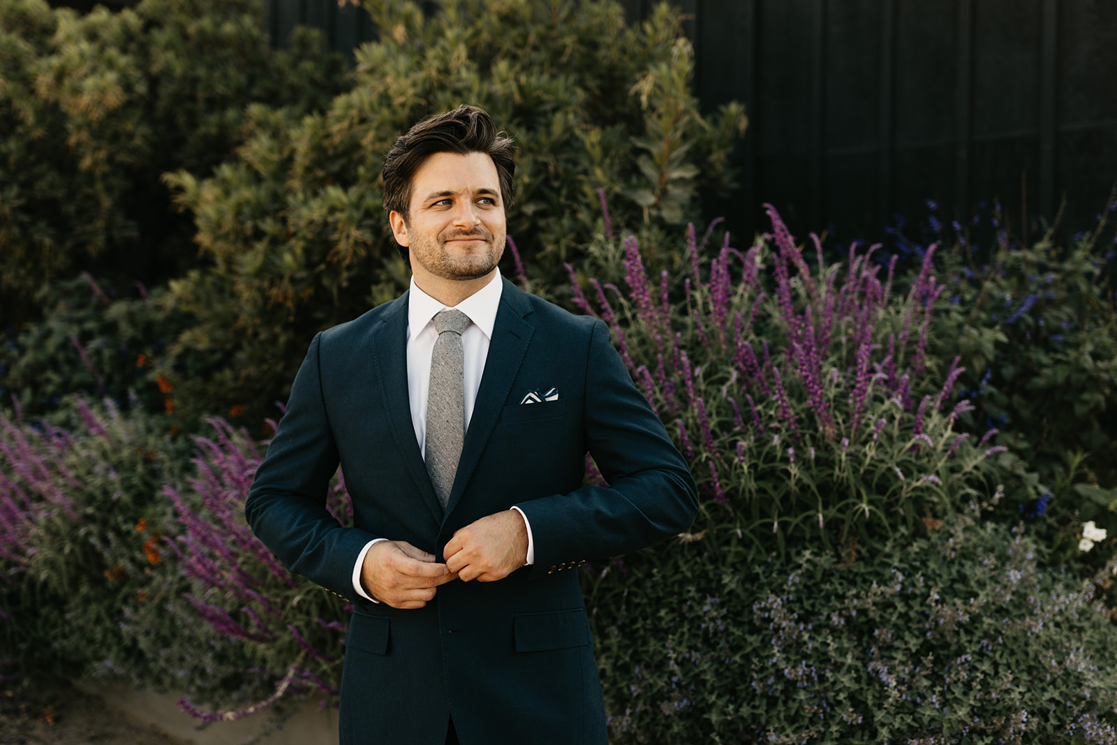 groom in dark blue suit portrait shot at Roblar Winery