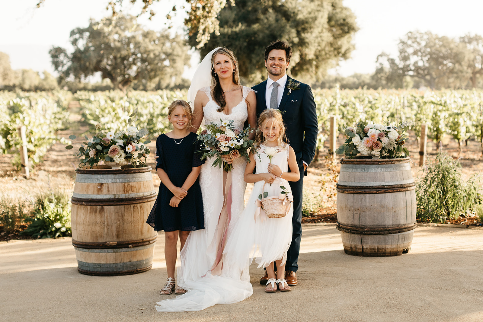 bride and groom with flower children at intimate vineyard wedding at Roblar Winery