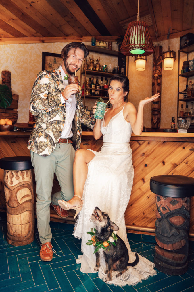 bride and groom backyard wedding cocktail hour in tiki bar