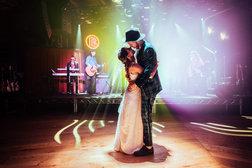 bride and groom dance at live music venue for this rock inspired wedding