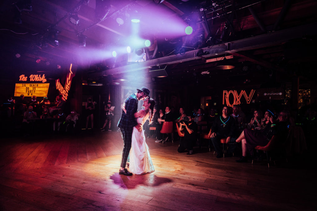bride and groom dance at live music venue for this rock inspired wedding