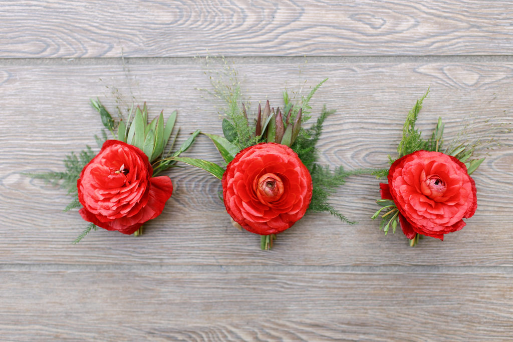 red groom boutonnieres