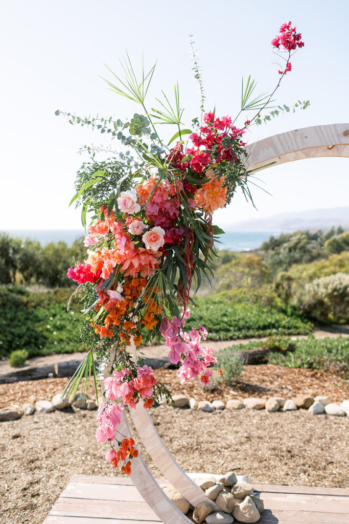 botanical wedding ceremony at Dos Pueblos Orchid Farm with a circle arch and bougainvillea 