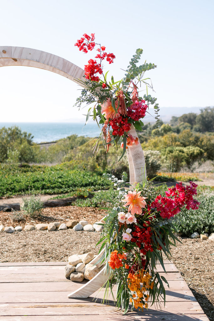 botanical wedding ceremony at Dos Pueblos Orchid Farm with a circle arch and bougainvillea 
