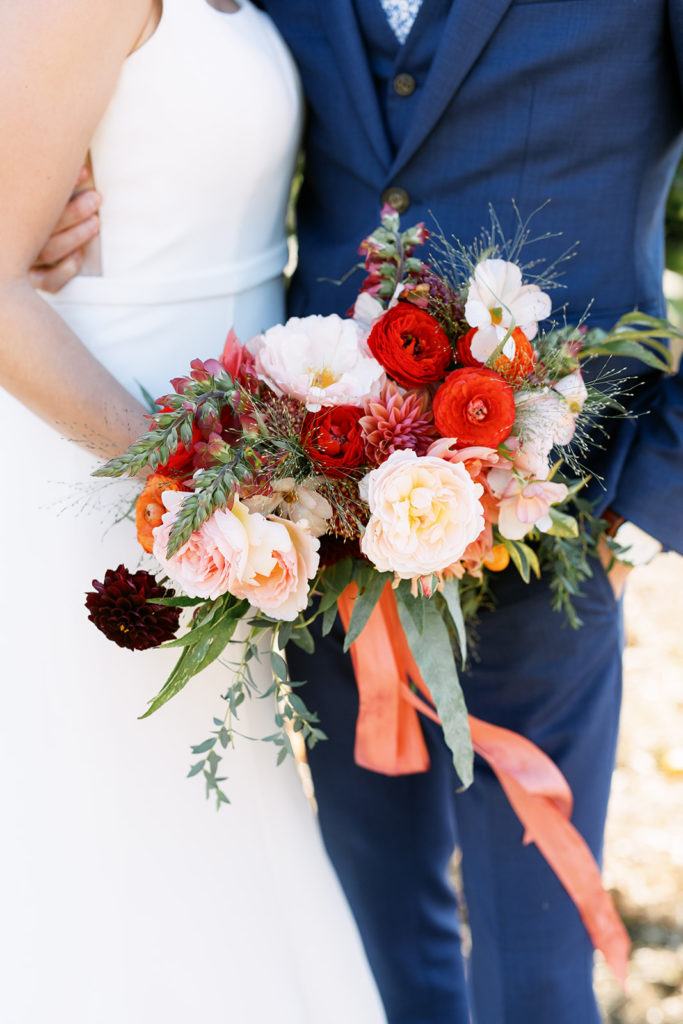bridal bouquet with red, orange and pink