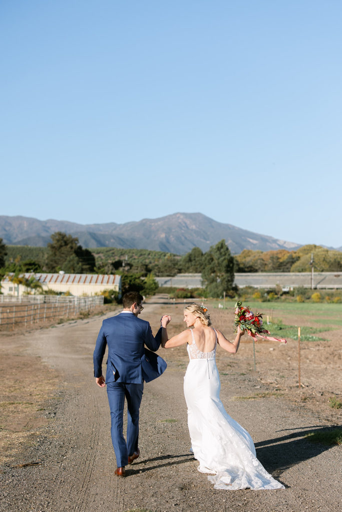 bride and groom walk towards reception at Dos Pueblos Orchid Farm