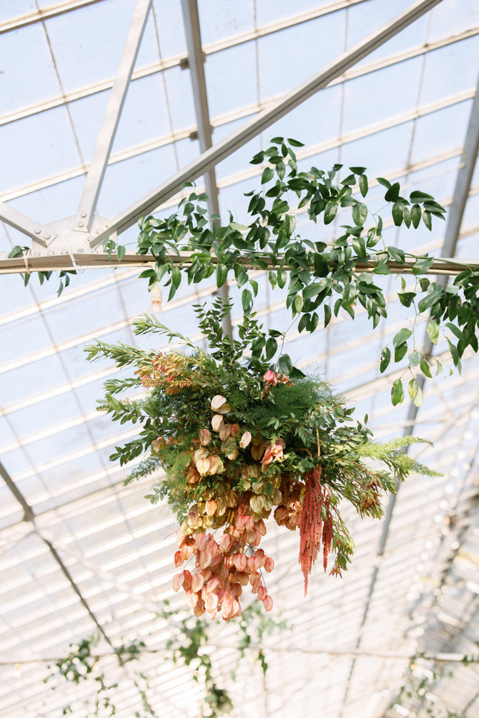 hanging greenery installation at botanical wedding reception at Dos Pueblos Orchid Farm
