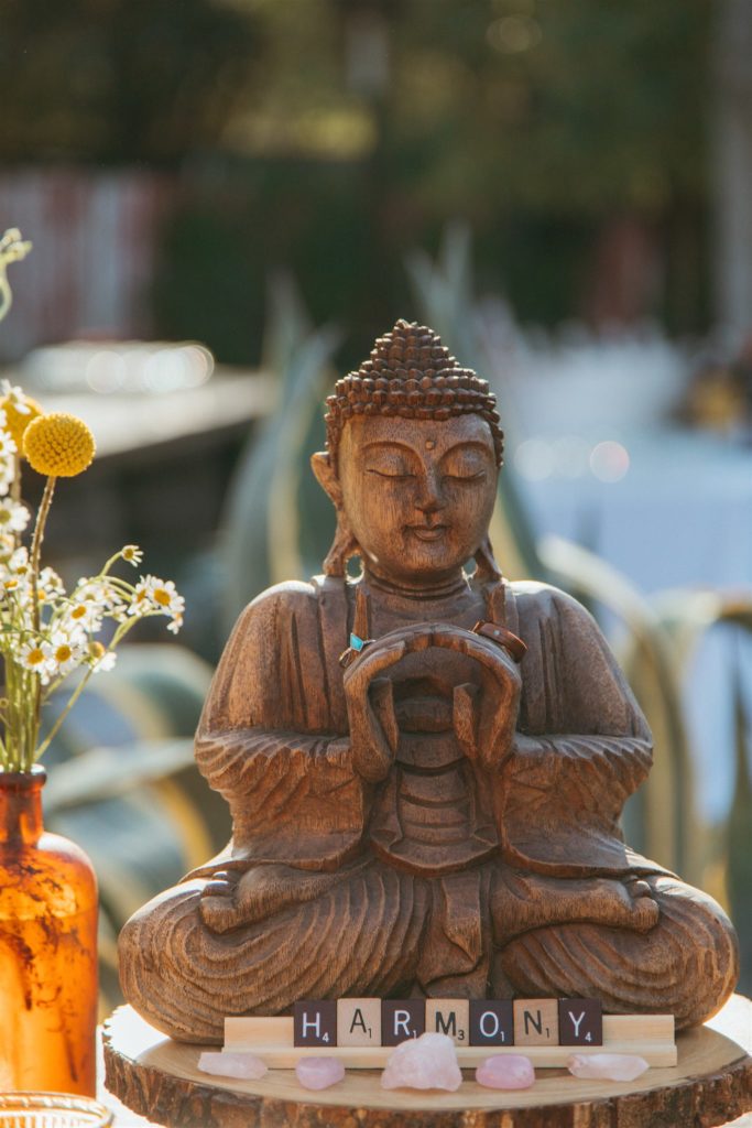 meditating buddha statue at welcome table