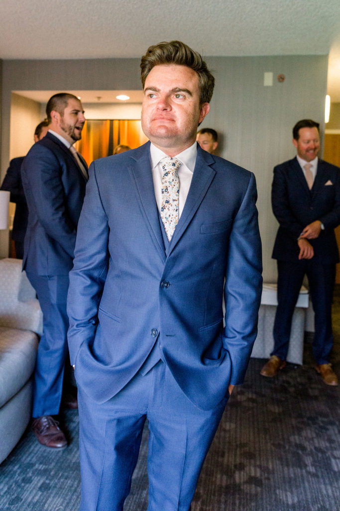 groom in blue suit with floral tie