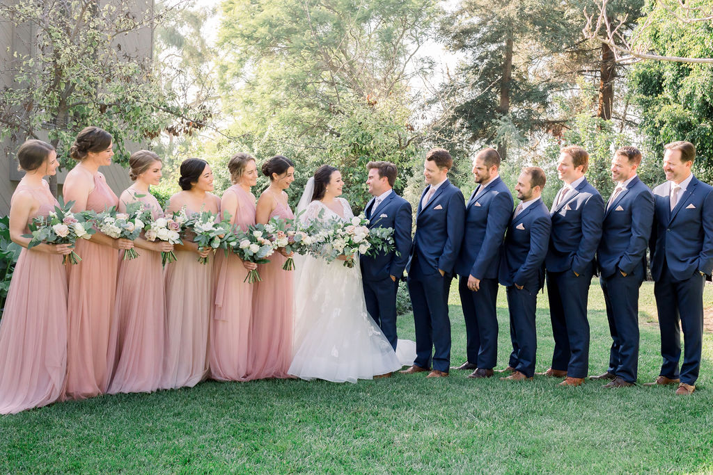 wedding party photo with pink bridesmaids photos and blue groomsmen suits at Maravilla Gardens
