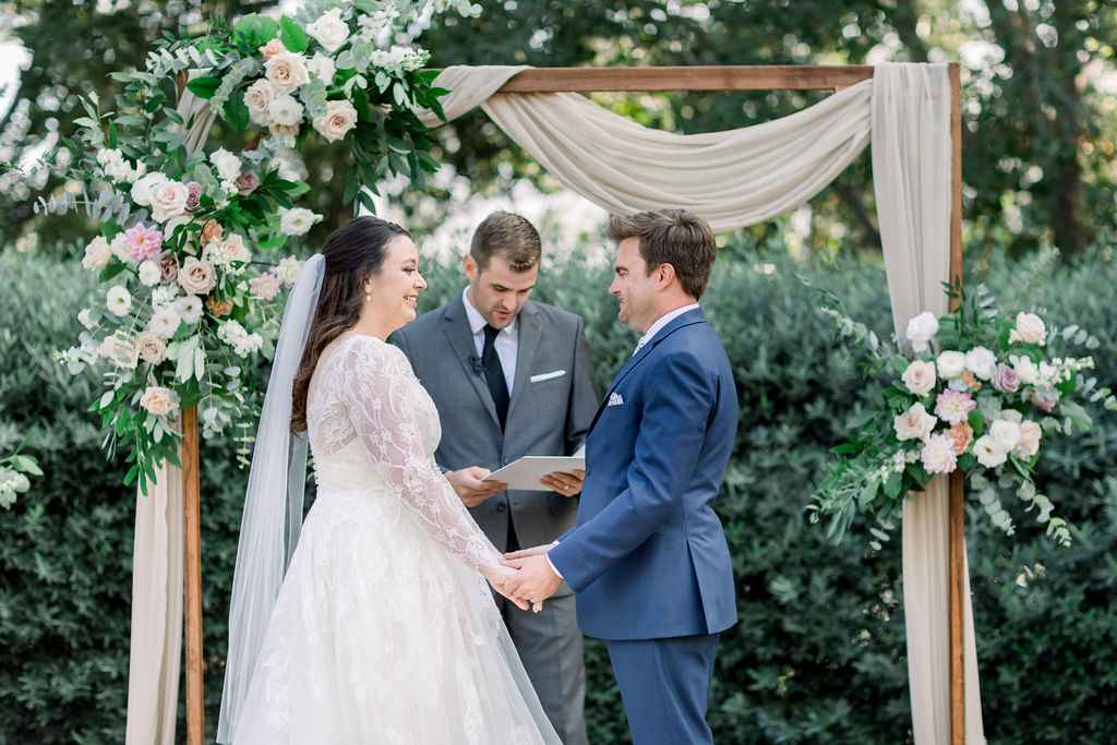 bride and groom exchange vows during charming wedding ceremony at Maravilla Gardens