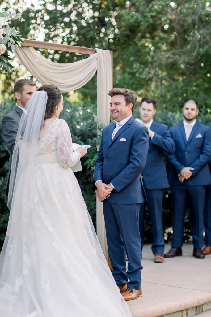 bride and groom exchange vows during charming wedding ceremony at Maravilla Gardens