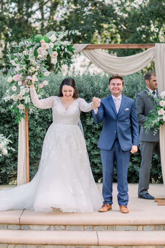 bride and groom recessional during charming wedding ceremony at Maravilla Gardens