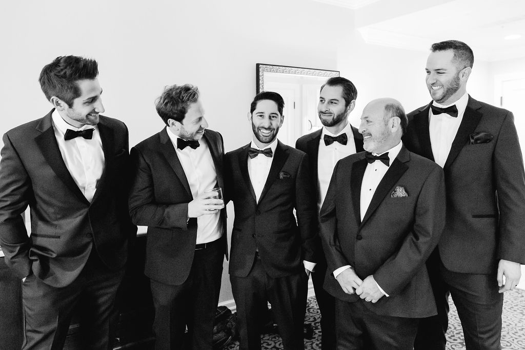 groom with groomsmen getting ready for wedding day