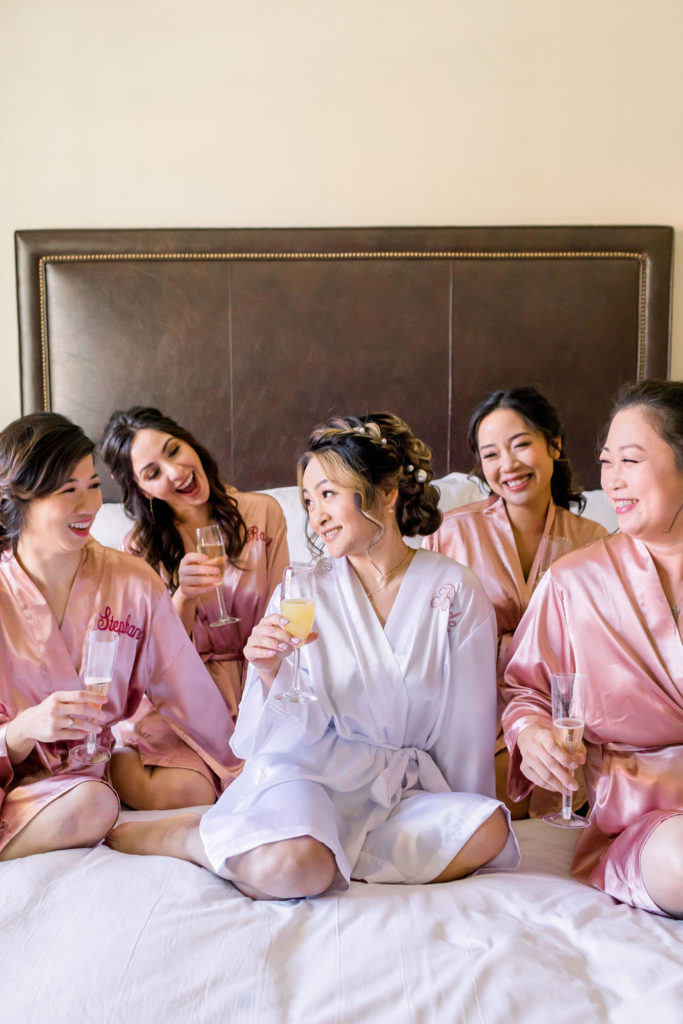 bride with bridesmaids in pink satin robes